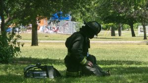 A firefighter sits in the shade after exiting the Parkside Apartments. With tempatures around 90, heat related illness is a major concern to the men and women battling fires.  Photo by Jaime Chapman