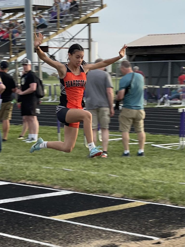 “Flying through the air with the greatest of ease!”  Beardstown’s Diana Huerta is shown mid-flight during the girls Sectional Track Meet.  Her leaping ability has her qualified for the IHSA State Final Track Meet this weekend in both the long jump and the triple jump.