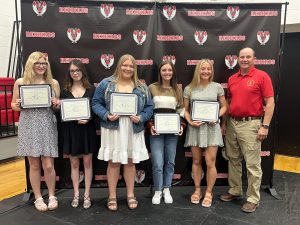 Virginia Masonic Lodge Master Terry Bell (right) presented scholarships to five Virginia High School seniors (left to right): Autumn Harris, $1,000 for vocational education; Kaylee Brown, $1,000; Emily Pratt, $1,000; Megan Reynolds, $1,000, and Gabby Young, $2,200 to be used at Lincoln Land Community College. The Virginia Masonic Lodge and The Illinois Masonic Children’s Assistance Program funded the scholarships. Photo by Steve Cl