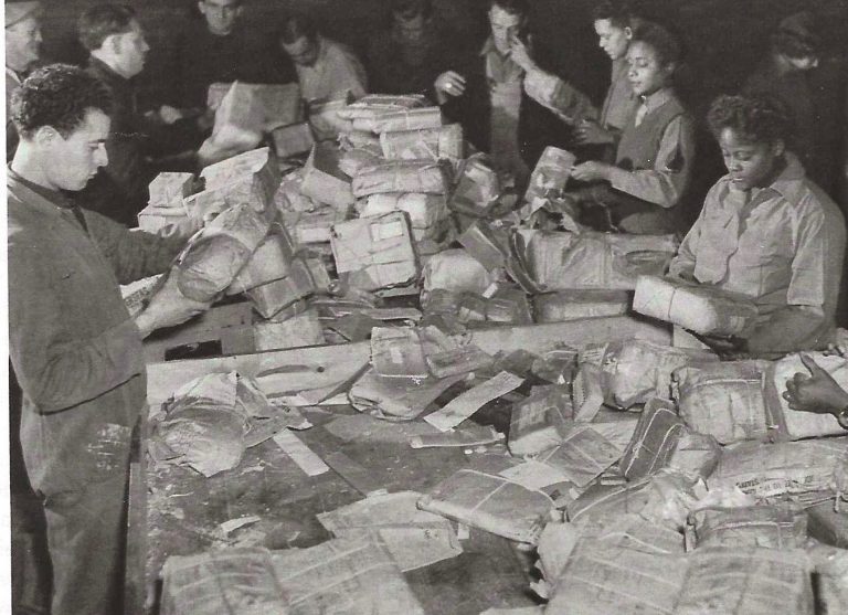 Members of the 6888th sorting mail, assisted by French volunteers