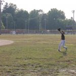The right fielder is in hot pursuit of a short pop up in Junior League Baseball action.