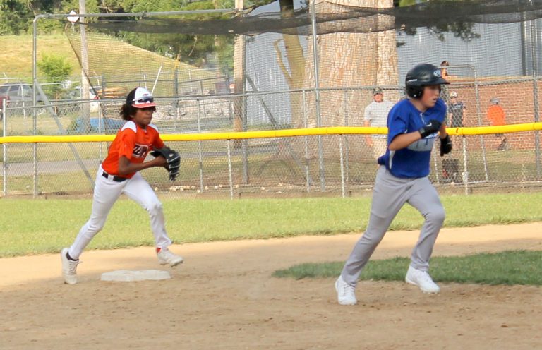 The Twins DeWade Gaffney gives chase to the Bluejays Evan Brewer in Little League baseball action.