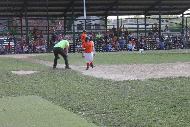 Base hit!  An Oriole cruises safely into first base with a single in the Minor League Baseball action.