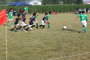 Pictured above Number 4 for JBS burst ahead of the pack in pursuit of the ball during a Beardstown Youth Soccer League game.