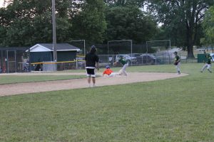 A Twins runner is safe at second with a stolen base in Little League baseball action.