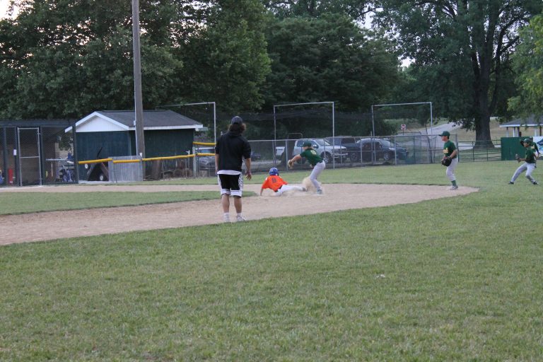 A Twins runner is safe at second with a stolen base in Little League baseball action.
