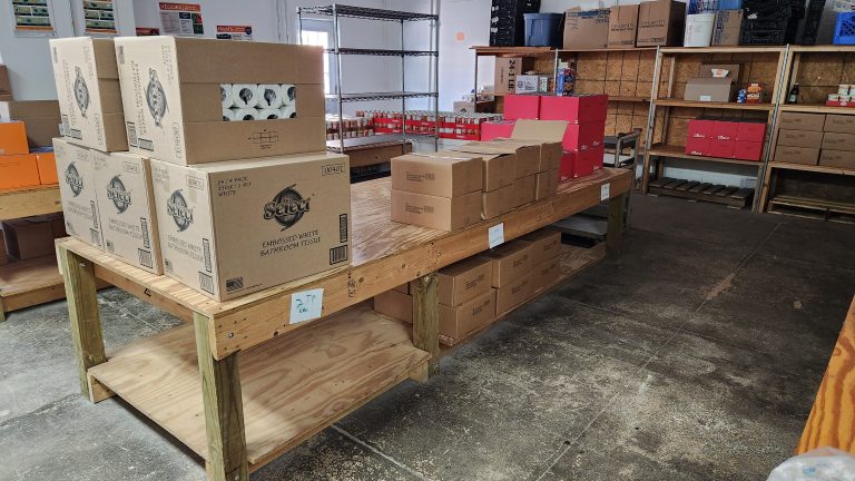 Tables and shelves that normally are full of food sit empty at the Cass County Food Pantry.