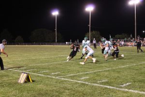 Running back Christy Domitien prepares to meet a tackler head on during the Tigers season opening loss to Carrollton.