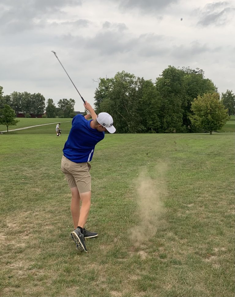 Trace Donnan of PORTA-AC Central stirs up some dust on impact on a dry golf course.