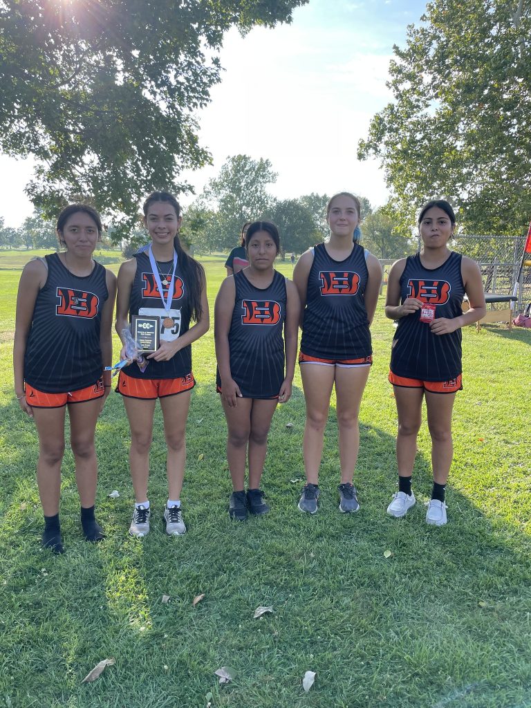 The girls' High School Cross Country team is pictured with their second place plaque from the Rushville-Industry Invite.