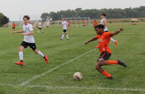 Josh Severino takes a shot on goal for BHS as the Athens defender closes in.