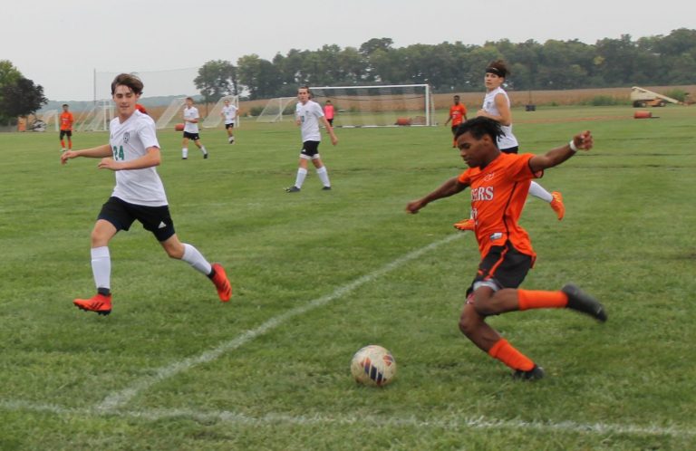 Josh Severino takes a shot on goal for BHS as the Athens defender closes in.