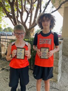 John Haverback (left) and Liam Hymes with their plaques from the Big 5 Conference Junior High Cross Country meet.