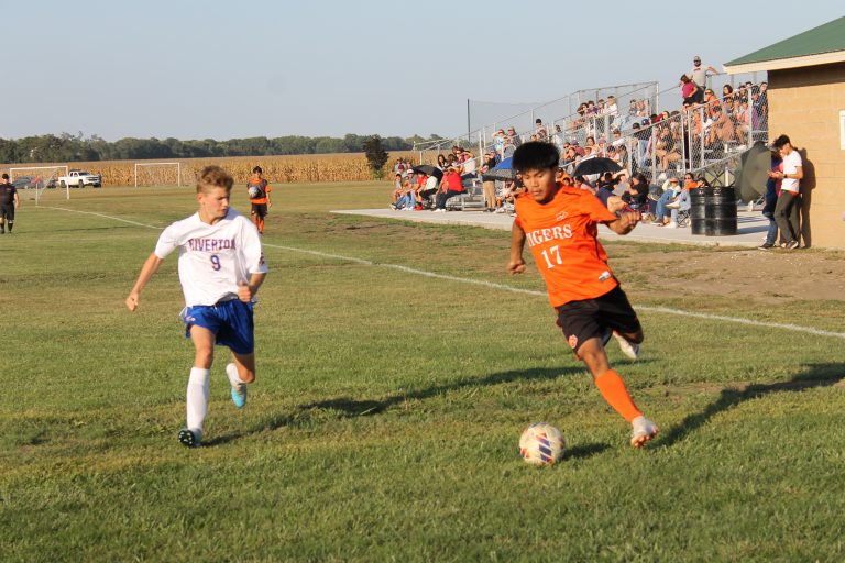 A nice crowd fills the new bleachers in the background at the Park District soccer field as Luis Rios is on the attack for BHS.