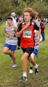 Beardstown’s Liam Hymes races on a slick and muddy course at the IESA State Finals Meet.