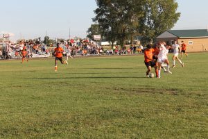 Michael Sevilla of the Tigers battles a Jacksonville Crimson for the ball in high school soccer action.
