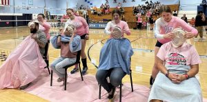 Members of the Triopia and Virginia staff take a pie to the face as part of the Annual Volley for the Cure game between Triopia-Virginia and Beardstown.