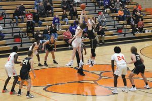 The Tiger’s Rylan Alhorn goes high to win the tip against Camp Point Central.