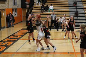 Bella Palmer powers through a couple of Wildcat defenders for the Lady Tigers.