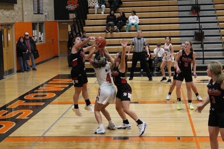 Bella Palmer powers through a couple of Wildcat defenders for the Lady Tigers.