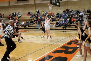 Ripping down a rebound for the Tigers is Carsen Hammack in a junior high hoops game.