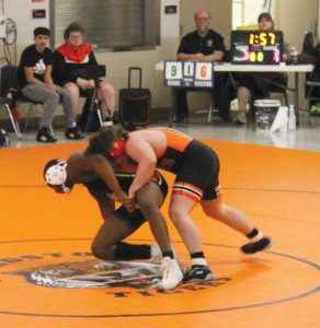 Gunner Looker takes down a Lanphier Lion for the Tigers in high school wrestling action.