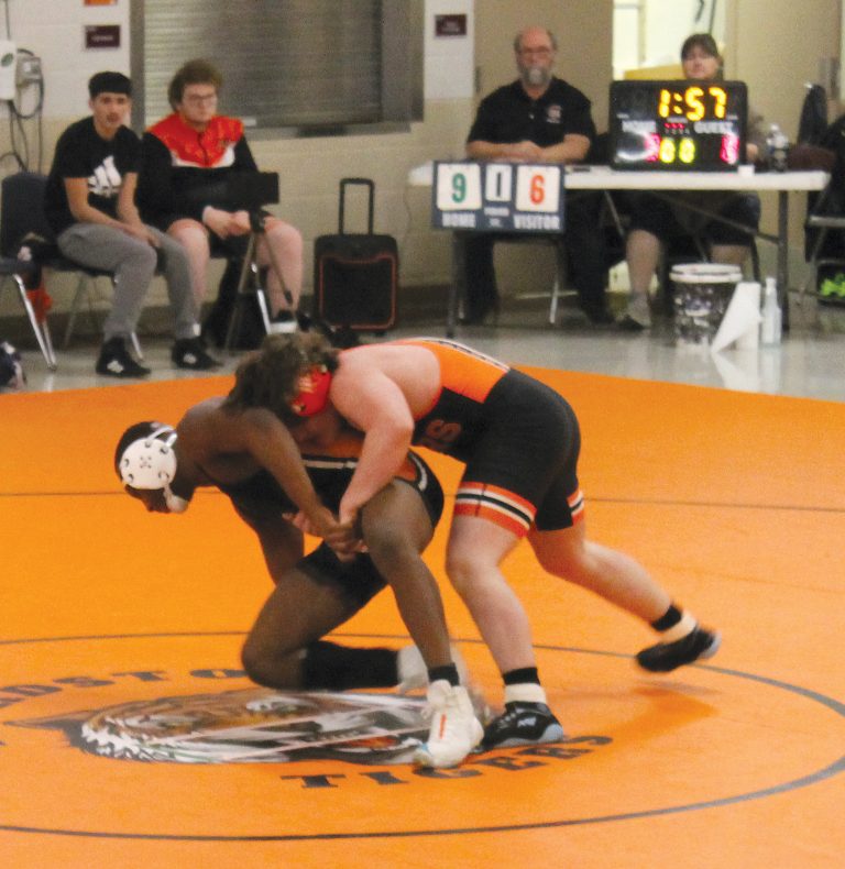 Gunner Looker takes down a Lanphier Lion for the Tigers in high school wrestling action.