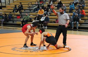Maddox Medrano gets really low as he prepares to attack for the Tigers in home wrestling action against Warrensburg-Latham.
