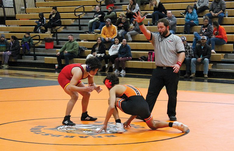 Maddox Medrano gets really low as he prepares to attack for the Tigers in home wrestling action against Warrensburg-Latham.