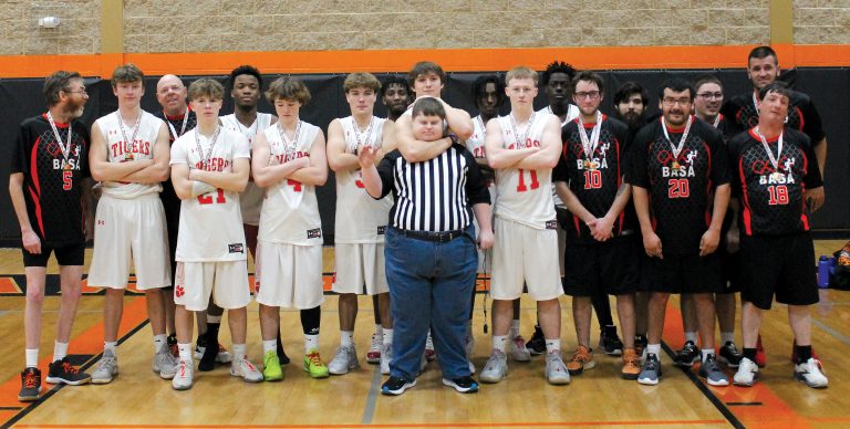 Following a very successful two-day 88 Hoops Classic basketball tournament, members of the BASA Black Attack and the BHS Tigers pose after their Classic capping game. In a game that was fun for everyone involved, the Black Attack won an exciting, high scoring affair over the varsity Tigers by three points.