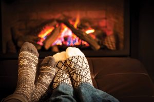 Socked feet by the fireplace.