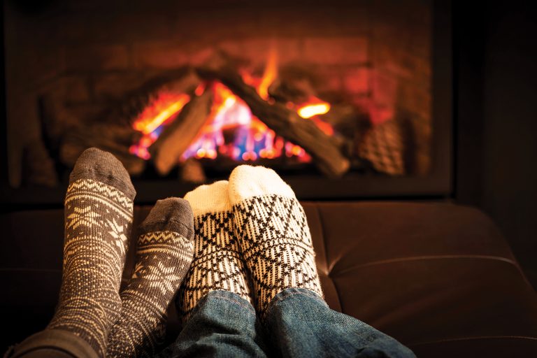 Socked feet by the fireplace.