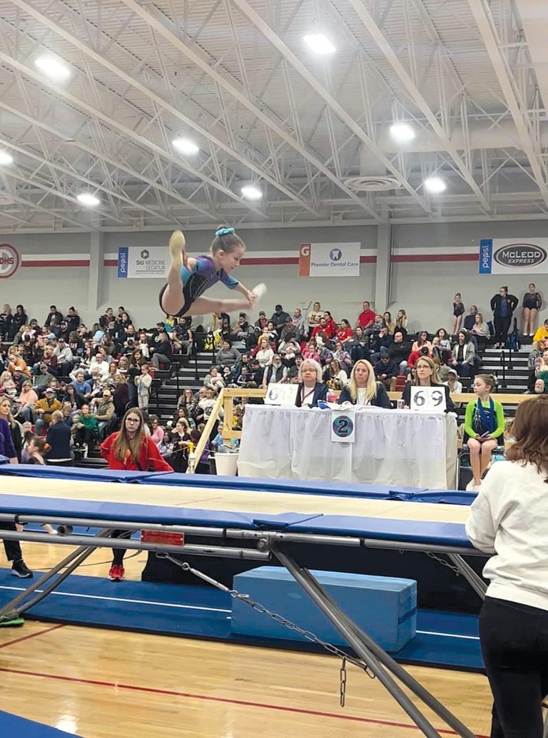 Kourtney Mustread is shown performing her novice level trampoline pass. She is in the 3/4th grade blended class at EJ Farm and Education with proud parents, Jeremy Mustread and Billy & Jessica McCurley of Bluffs.