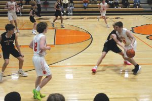 Beardstown's Payton McCoy handles the ball under some extreme pressure in JV basketball action against Western.