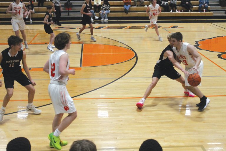 Beardstown's Payton McCoy handles the ball under some extreme pressure in JV basketball action against Western.