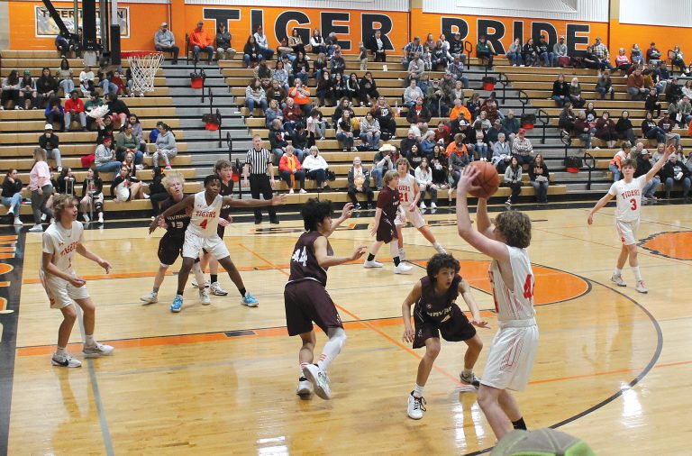 The Tiger’s Parker McCoy looks to feed the ball inside to Ephrem Kayembe (#4).