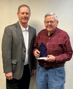 Kai Schnitker (left), president of the First National Bank of Arenzville, presents Donald Pigg (right) with the Blue Diamond Community Service Award on February 6.
