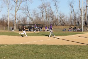 “Up Easy;” Coach Brian Dour tells Zach DeSollar as he heads to third base in the Tigers baseball opener.