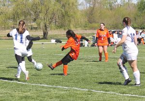 Xixi Marquez scores for BHS despite four Riverton defenders and the goalie between her and the goal.