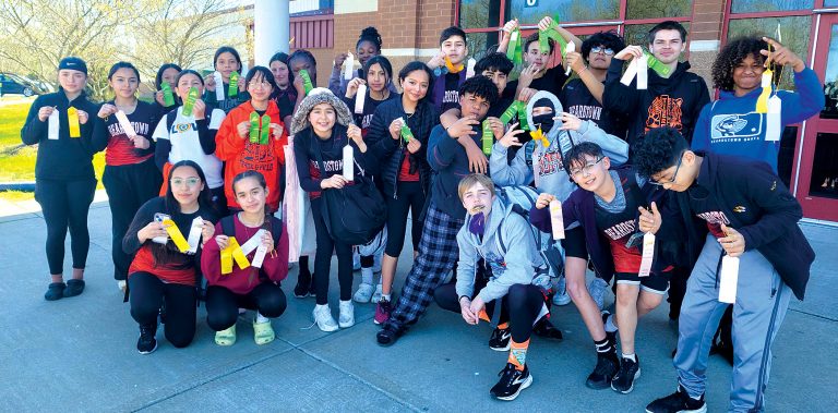 A joyous Tiger Junior High Track team proudly displays their ribbons from last Saturday’s Schuyler-Industry Meet.