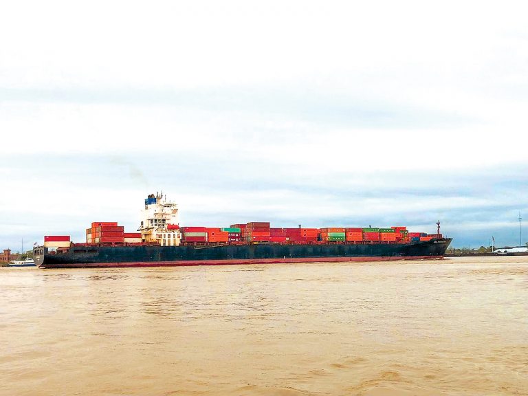A container vessel traverses the Mississippi River near New Orleans. Water levels on the Mighty Mississippi recovered in recent weeks, which triggered the removal of draft restrictions. Photo by Daniel Grant