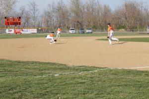 Tiger shortstop Colby DeSollar moves into position for a ground ball in home baseball action.