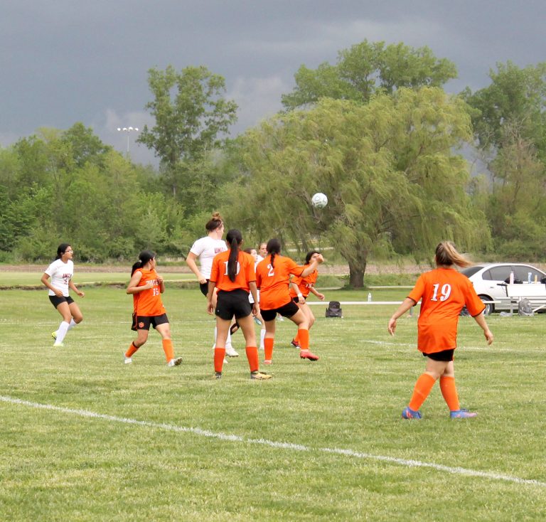 The Beardstown defense is well positioned as an ominous storm cloud closes in on the soccer field. Photo by Brockschmidt