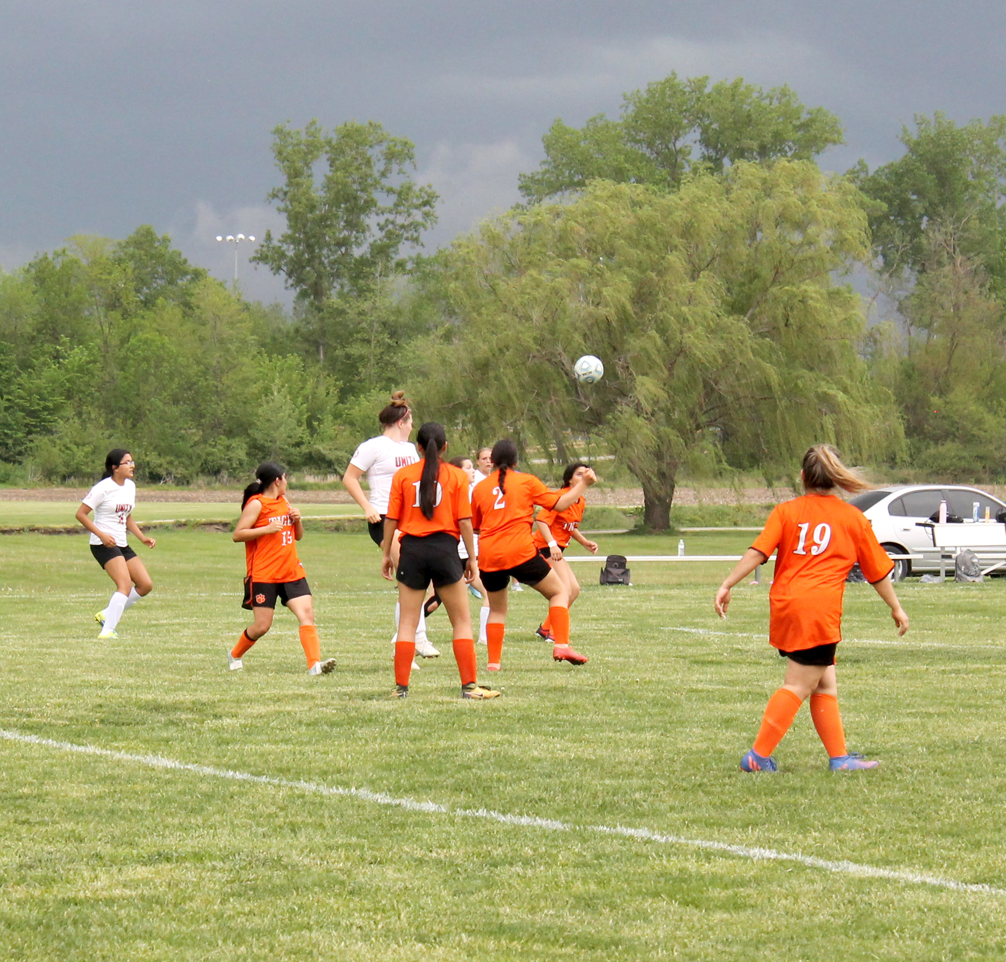 The Beardstown defense is well positioned as an ominous storm cloud closes in on the soccer field. Photo by Brockschmidt