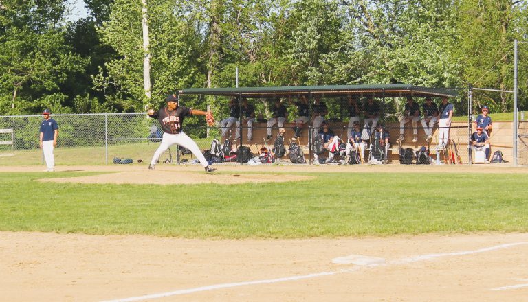 Senior Gustavo Cortes delivers the pitch for the Tigers against Illini West.