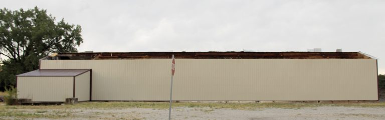 Storms hit Beardstown on Tuesday, June 25 causing damage to several properties in the area. Trees fell on homes, poles were snapped off, power lines were downed. The public works storage shed (top photo) lost the entire west half of its roof. Gary Hamilton, Public Works Director, stated that most of the damage was south of 10th Street to the highway. Work has begun on clean up and to restore power, cable and phone lines. Photos by Michelle Carty