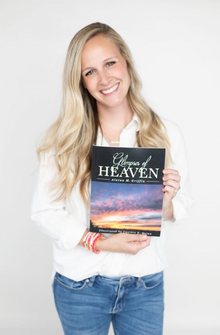 Alaina M. Griffin holding a copy of her book “Glimpses of Heaven” Photo by Samantha Jo Photography