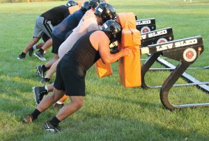 “Keep your feet moving!” Coach Craig can be heard encouraging the linemen at BHS Varsity Football Camp.