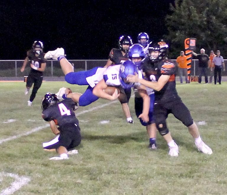 Zach Meyer (#4) and Caleb Hobrock send a Wolf airborne in the Tigers home game against Pleasant Hill.