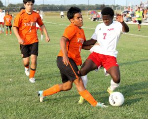 Jason Gil tries to poke the ball away from a Cardinal.